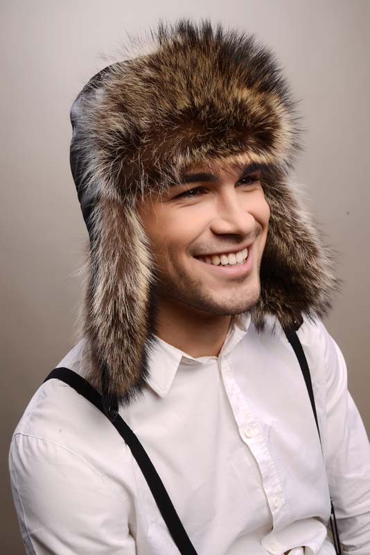Brown mens fur hat, fashioned from nappa lamb leather, combined with natural raccoon fur, material that is used for the lining